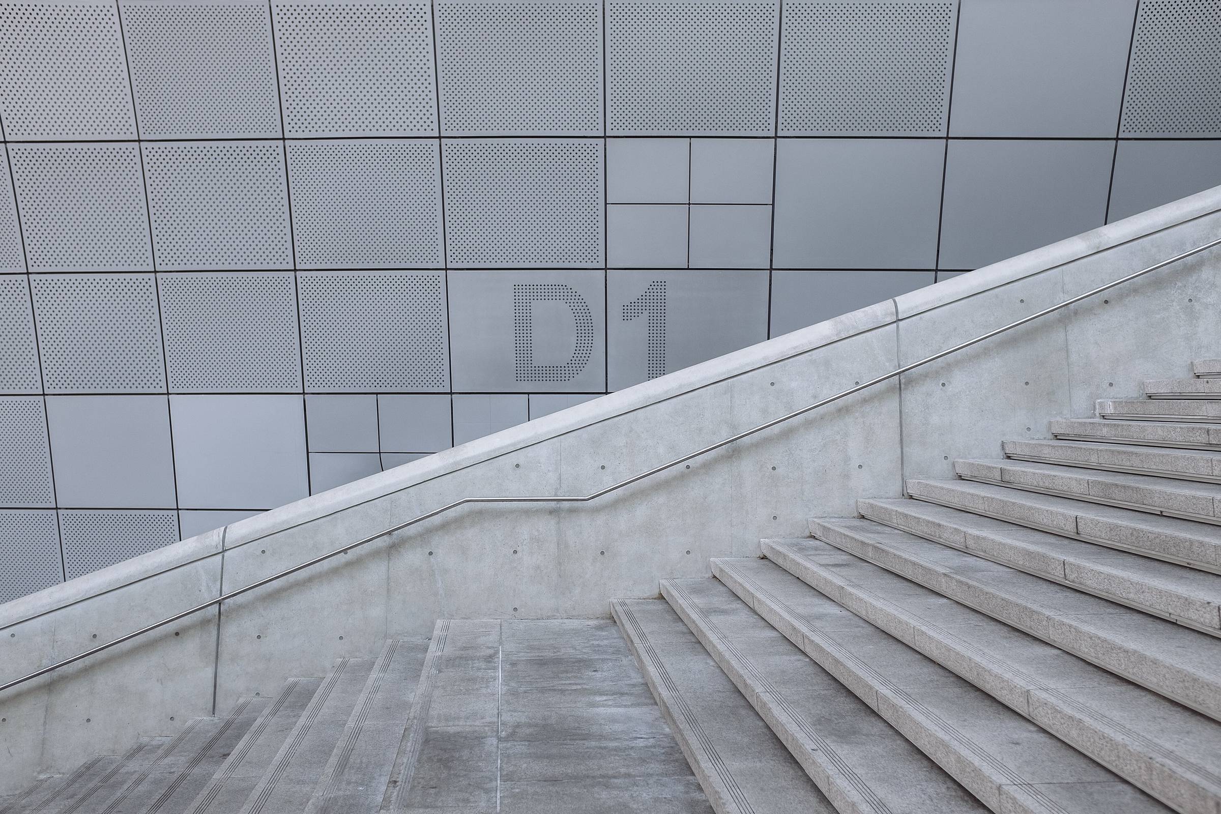 A concrete stair flight photographed as a diagonal band in monochrome.