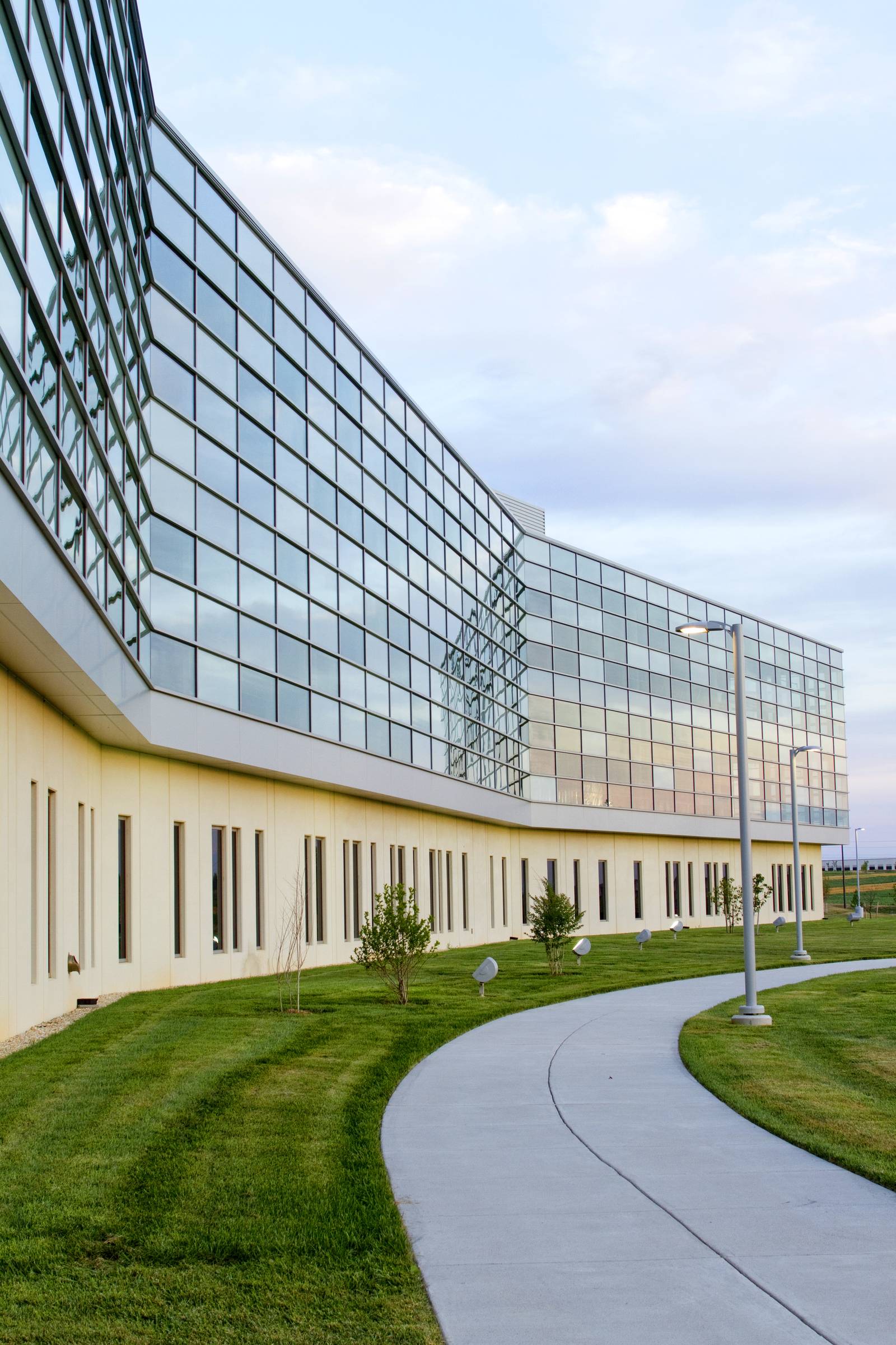 The glazed elevation of a modern research institute building seen against the sky.